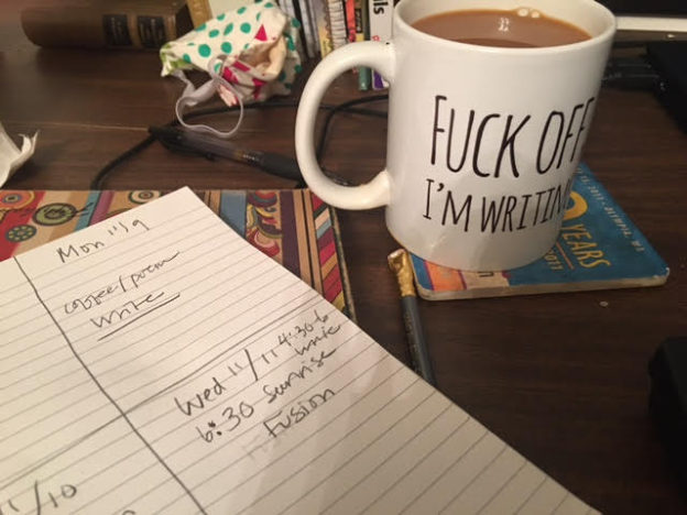 cup on desk with writing plan
