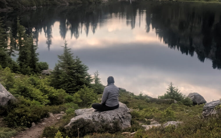 Woman Sitting On Rock